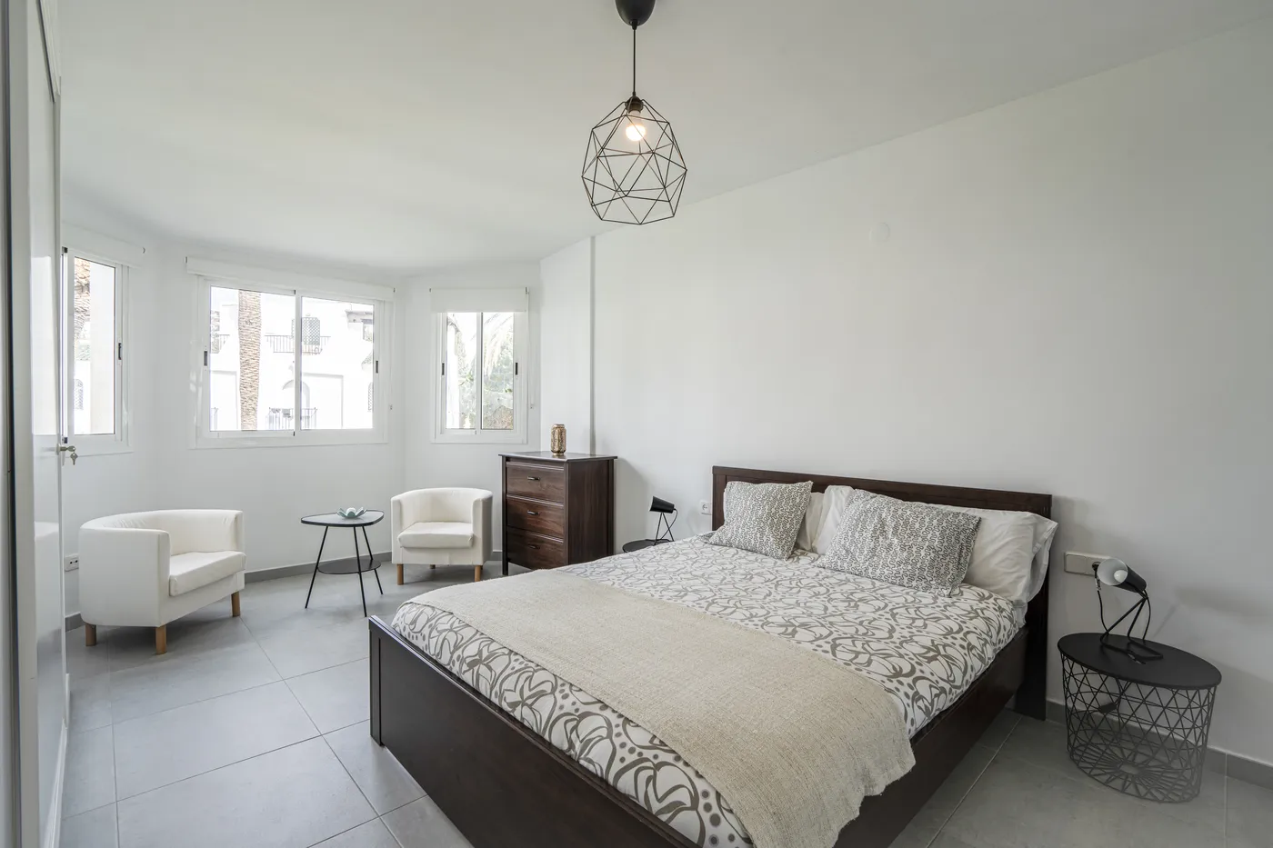 El dormitorio principal antes: una cama sencilla y paredes desnudas.